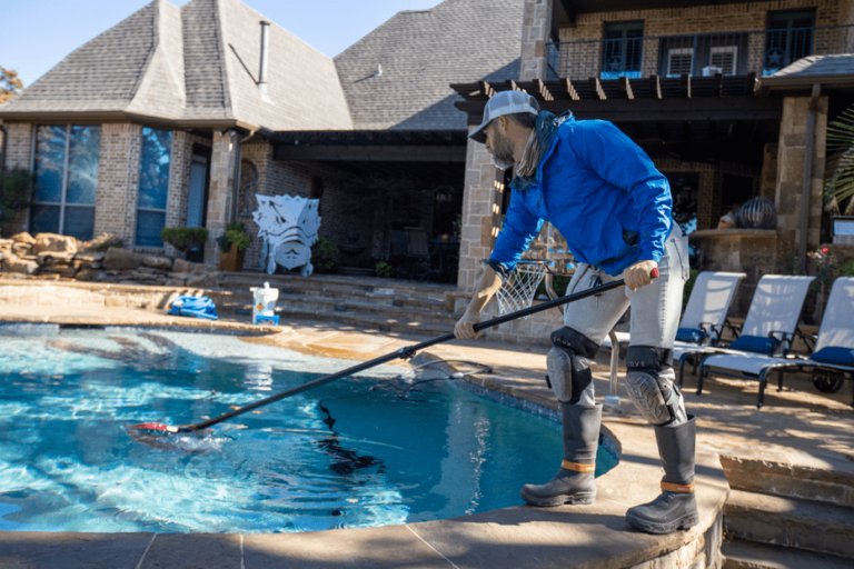Pool technician with net by pool