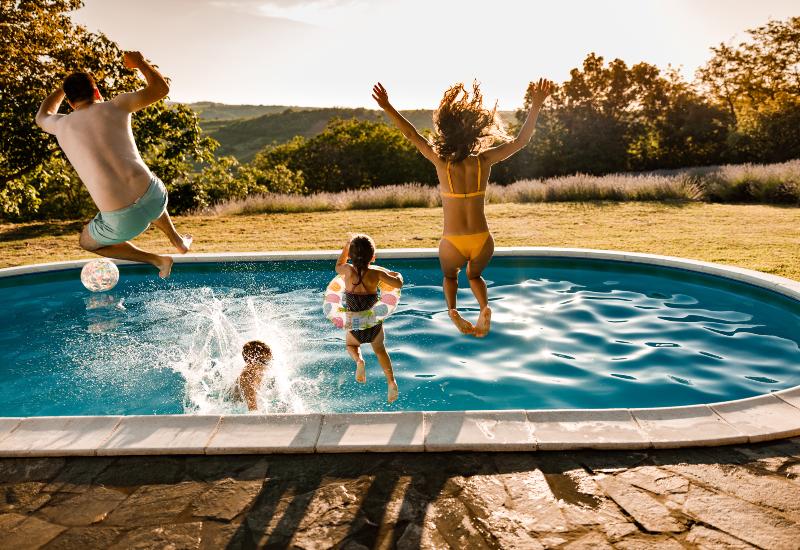 Family jumping in pool